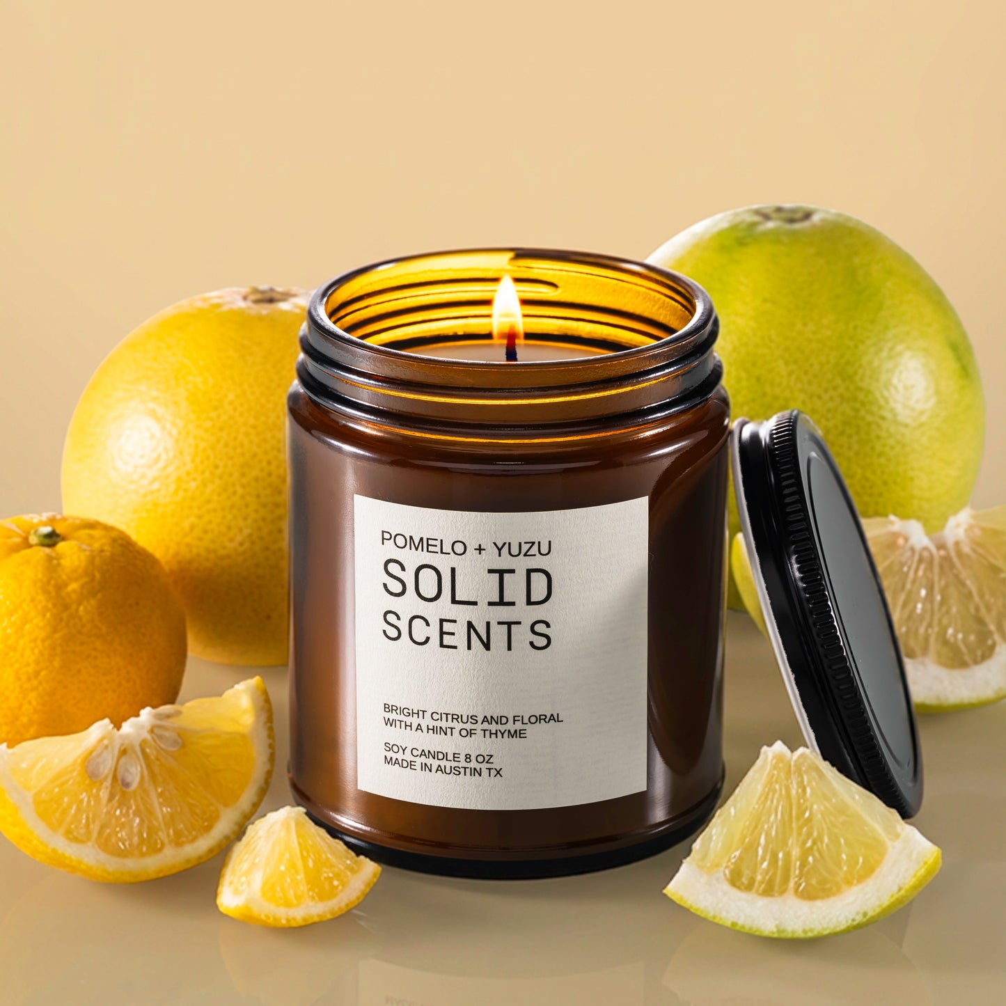 Solid Scents candle with pomelo and yuzu fruits on a reflective surface